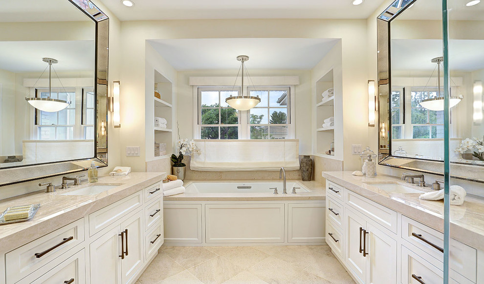 Inspiration for a large traditional master bathroom in Los Angeles with shaker cabinets, white cabinets, a drop-in tub, a corner shower, beige tile, porcelain tile, beige walls, porcelain floors, an undermount sink, quartzite benchtops, beige floor, a hinged shower door and beige benchtops.