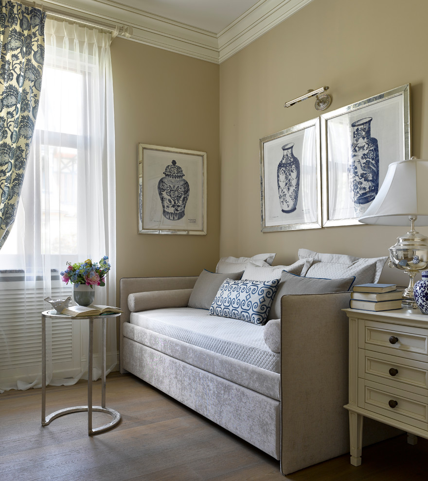Traditional bedroom in Moscow with beige walls, medium hardwood floors and brown floor.