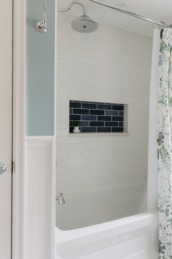 Small classic bathroom in Other with an alcove bath, an alcove shower, a bidet, white tiles, metro tiles, blue walls, porcelain flooring, a console sink, white floors, a shower curtain, white worktops, a single sink, a freestanding vanity unit and wainscoting.