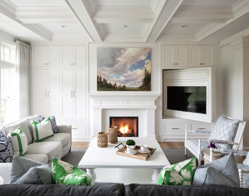 Inspiration for a transitional living room in Minneapolis with white walls, medium hardwood floors, a standard fireplace, a brick fireplace surround and brown floor.