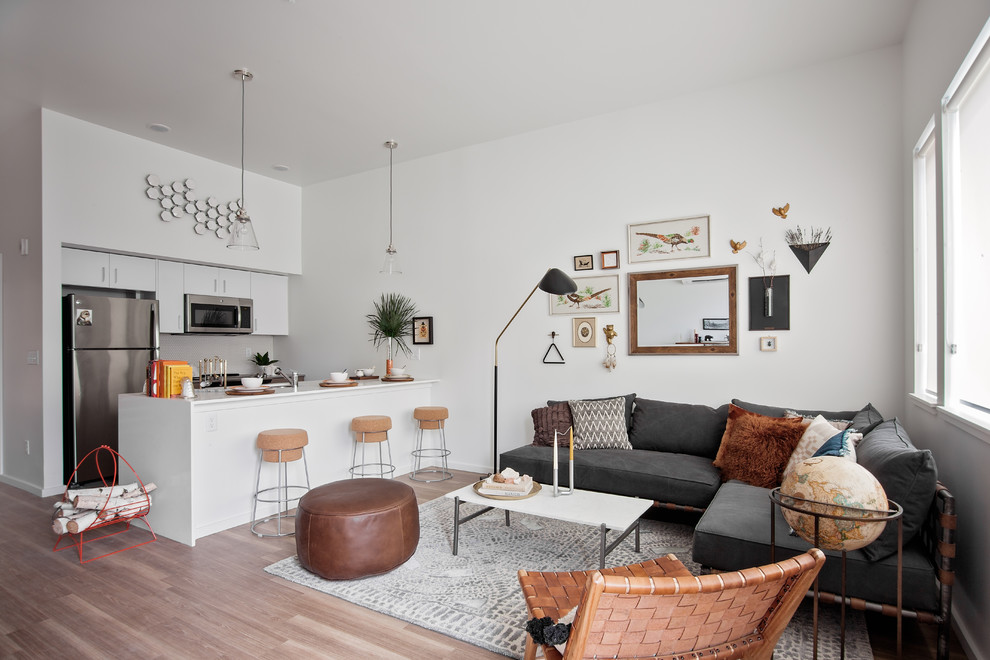 Contemporary open concept living room in Portland with white walls, medium hardwood floors and brown floor.