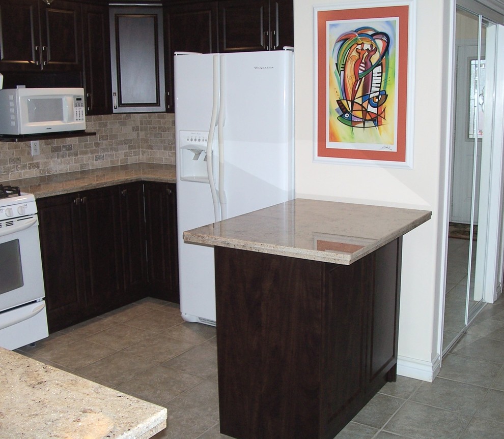 Photo of a mid-sized u-shaped kitchen in Toronto with an undermount sink, white appliances, a peninsula, dark wood cabinets, granite benchtops, beige splashback and travertine splashback.