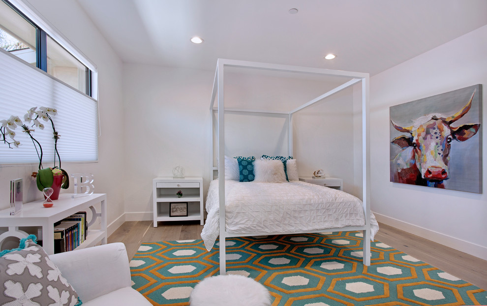 Photo of a mid-sized contemporary guest bedroom in Orange County with white walls, ceramic floors, a standard fireplace and a plaster fireplace surround.