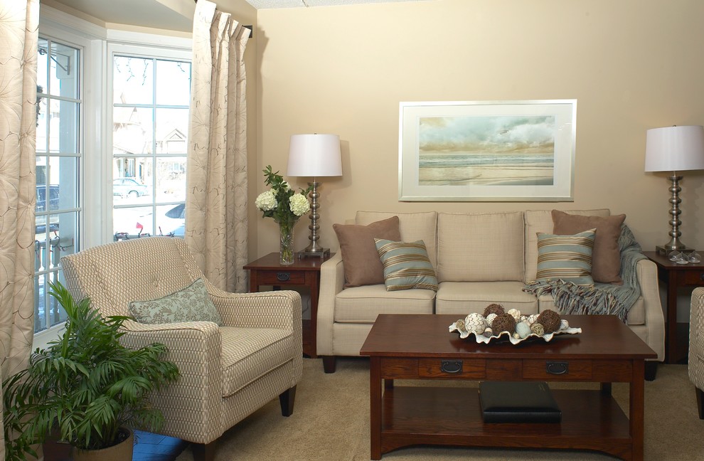 This is an example of a mid-sized transitional open concept living room in Toronto with beige walls and medium hardwood floors.