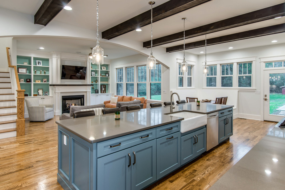 This is an example of a large transitional l-shaped open plan kitchen in Nashville with recessed-panel cabinets, blue cabinets, quartzite benchtops, green splashback, stone tile splashback, stainless steel appliances, medium hardwood floors and with island.