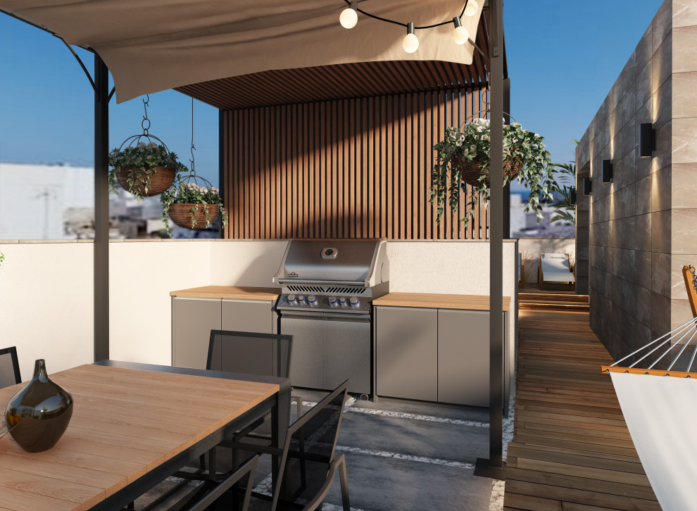 Inspiration pour une terrasse sur le toit minimaliste avec une cuisine d'été, une pergola et un garde-corps en verre.