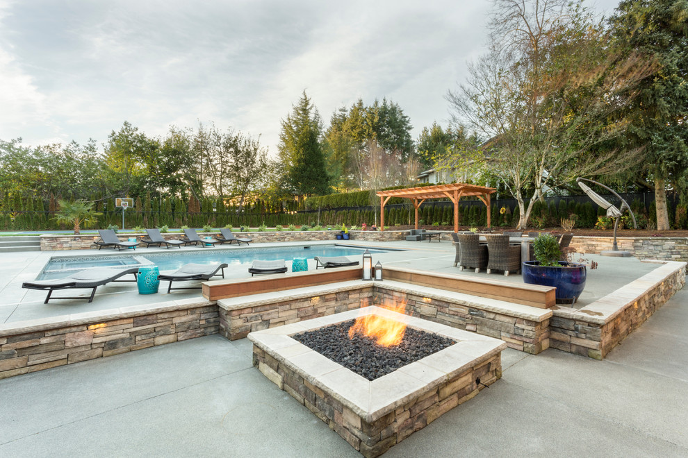 Inspiration for an expansive transitional backyard rectangular lap pool in Portland with a hot tub and concrete slab.