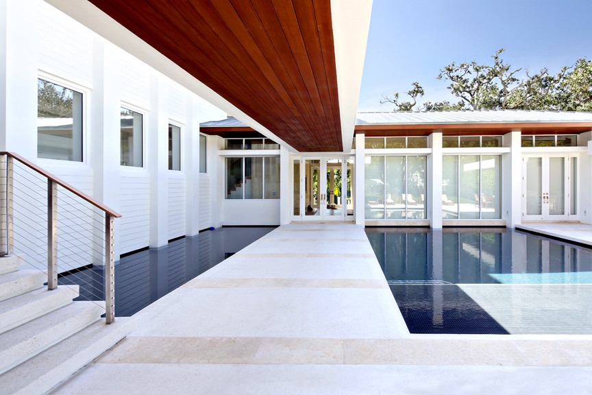 Contemporary courtyard custom-shaped pool in Miami.