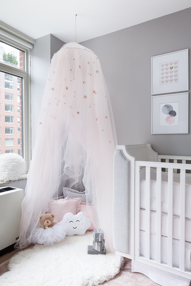 Small transitional girl carpeted and pink floor nursery photo in New York with gray walls