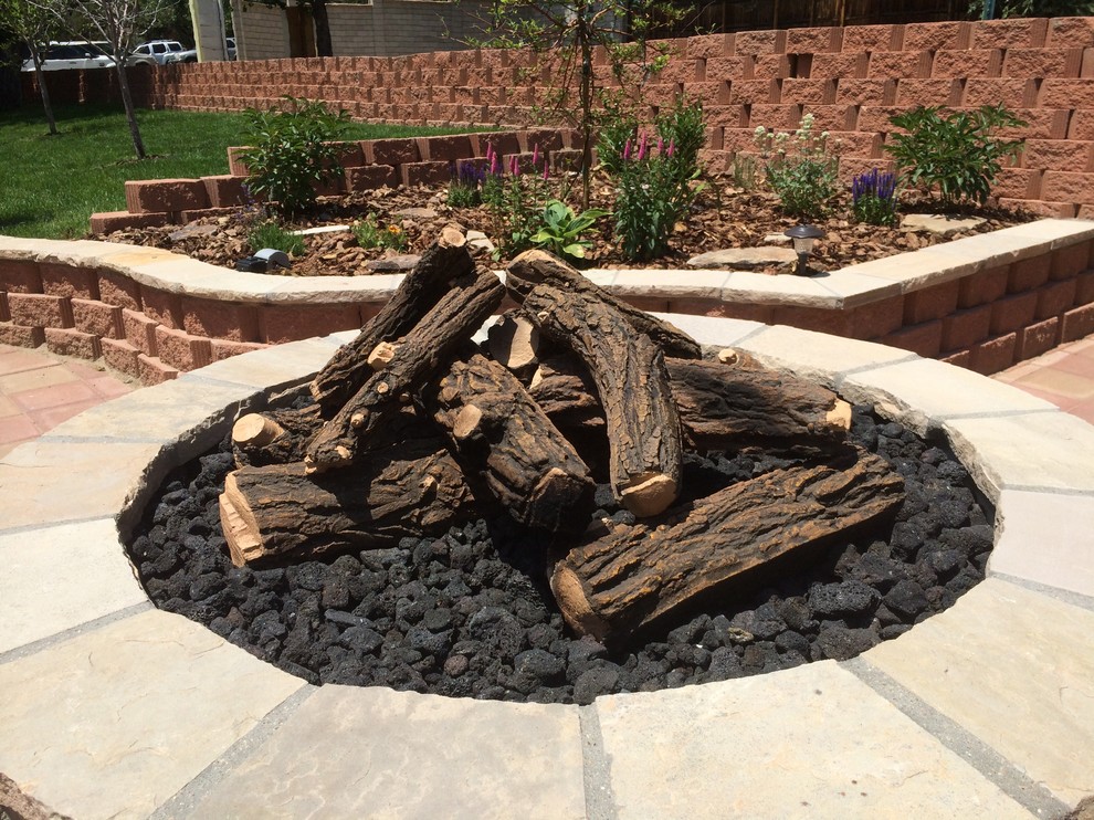 Inspiration for a large contemporary backyard garden in Denver with a fire feature.