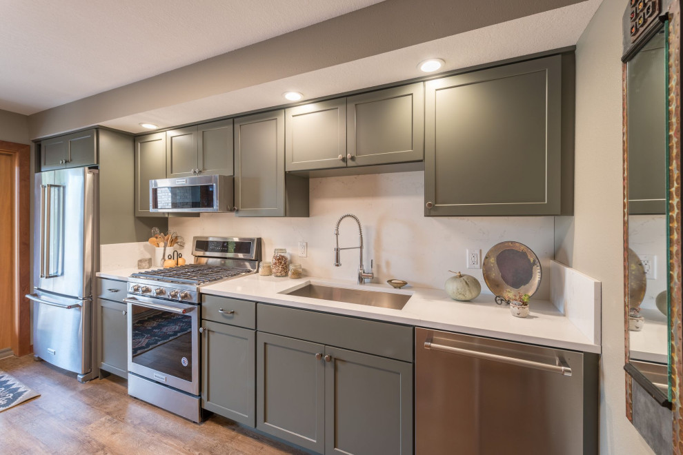 Example of a mid-sized transitional galley linoleum floor and brown floor kitchen design in Minneapolis with an undermount sink, shaker cabinets, gray cabinets, quartzite countertops, white backsplash, stone slab backsplash, stainless steel appliances, no island and white countertops