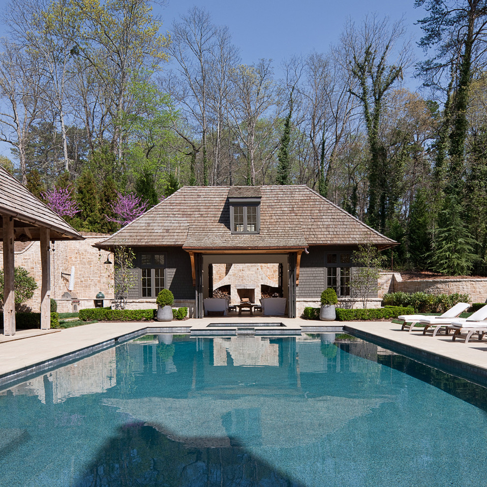 Design ideas for a large transitional backyard rectangular lap pool in Atlanta with a hot tub and natural stone pavers.