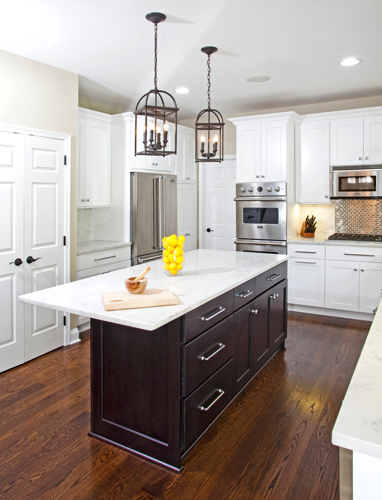 This is an example of a mid-sized transitional l-shaped eat-in kitchen in Philadelphia with a single-bowl sink, shaker cabinets, white cabinets, marble benchtops, white splashback, stone tile splashback, stainless steel appliances, dark hardwood floors and with island.