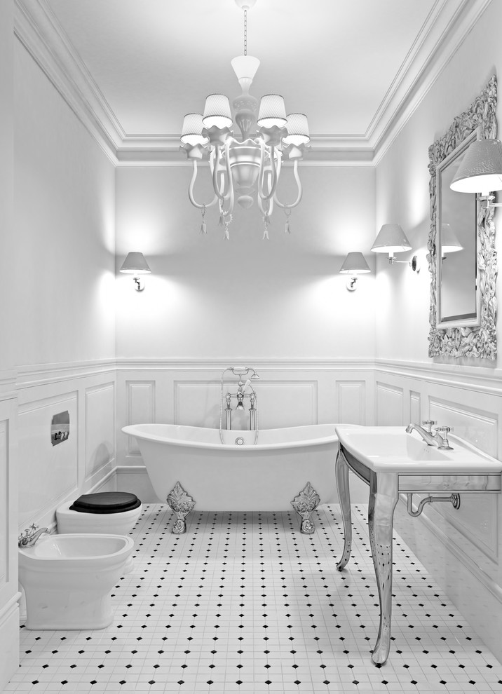 Photo of a mid-sized traditional 3/4 bathroom in Orange County with white cabinets, a claw-foot tub, a one-piece toilet, white tile, ceramic tile, white walls, ceramic floors, a drop-in sink, solid surface benchtops, white floor and open cabinets.