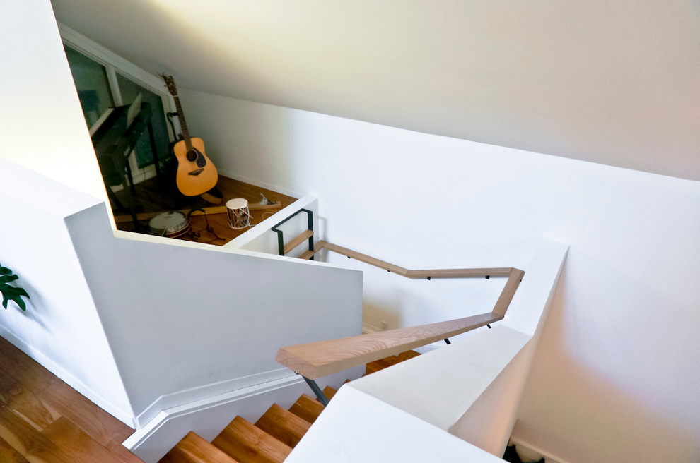 Photo of a small midcentury u-shaped staircase in Other.