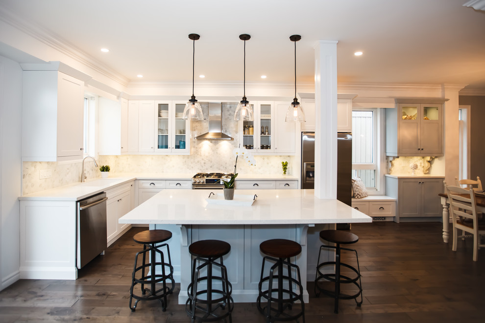 Example of a mid-sized transitional galley dark wood floor eat-in kitchen design in Toronto with an undermount sink, shaker cabinets, white cabinets, granite countertops, white backsplash, stone tile backsplash, stainless steel appliances and an island