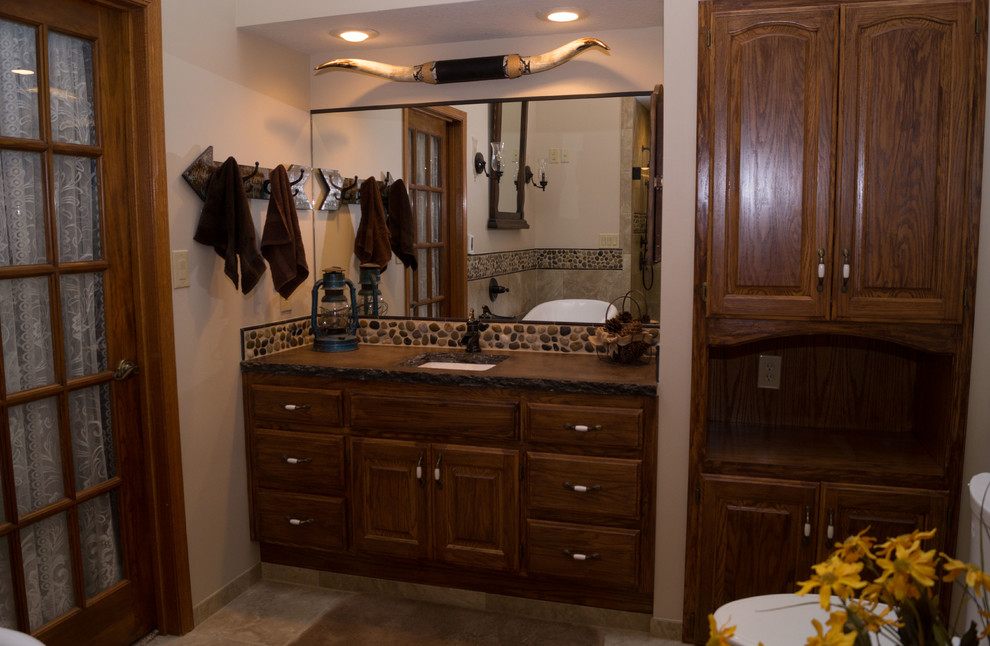 Large master bathroom in Other with raised-panel cabinets, medium wood cabinets, a claw-foot tub, an alcove shower, a two-piece toilet, multi-coloured tile, ceramic tile, beige walls, ceramic floors, an undermount sink and concrete benchtops.
