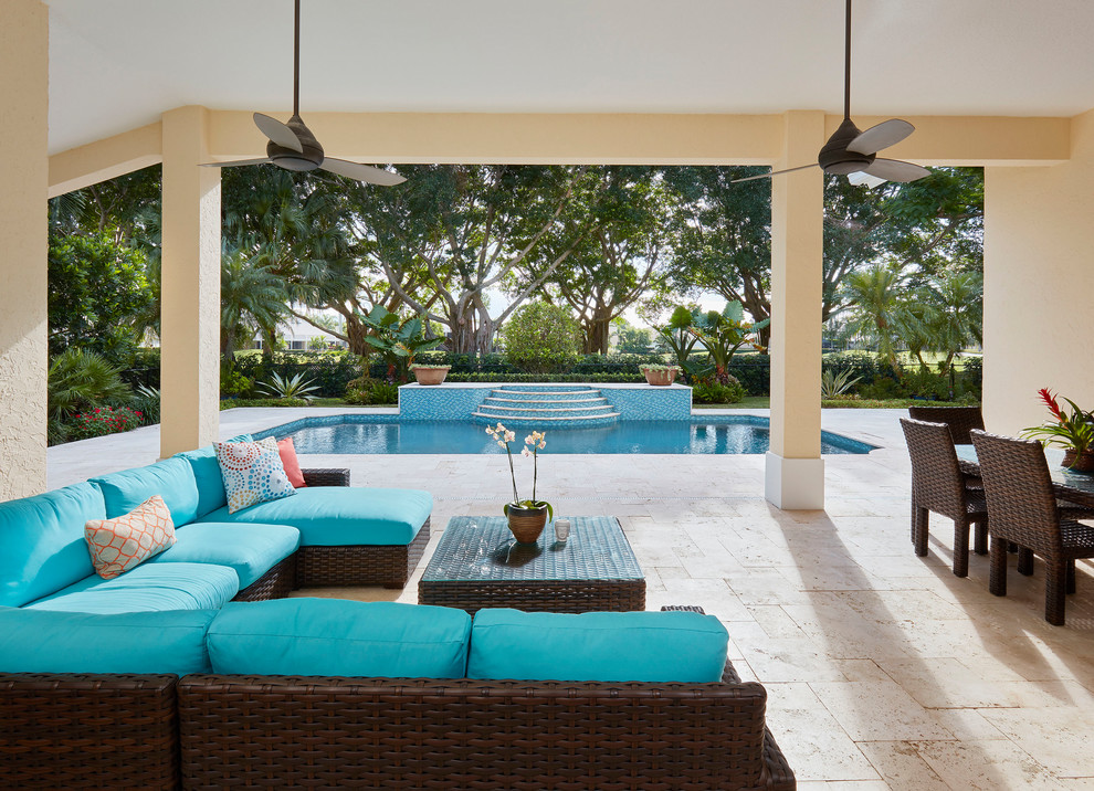 Photo of a beach style patio in Miami with a roof extension.