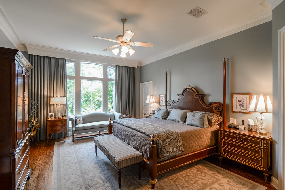 Inspiration for a large timeless master medium tone wood floor bedroom remodel in New Orleans with gray walls and no fireplace