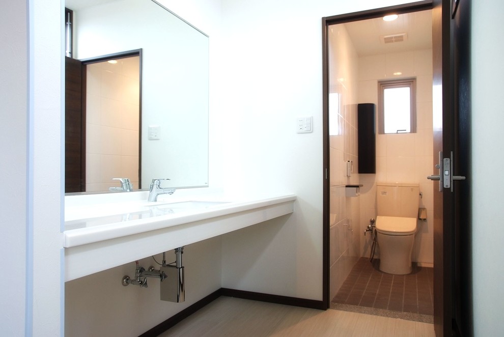 Contemporary powder room in Other with white walls and light hardwood floors.