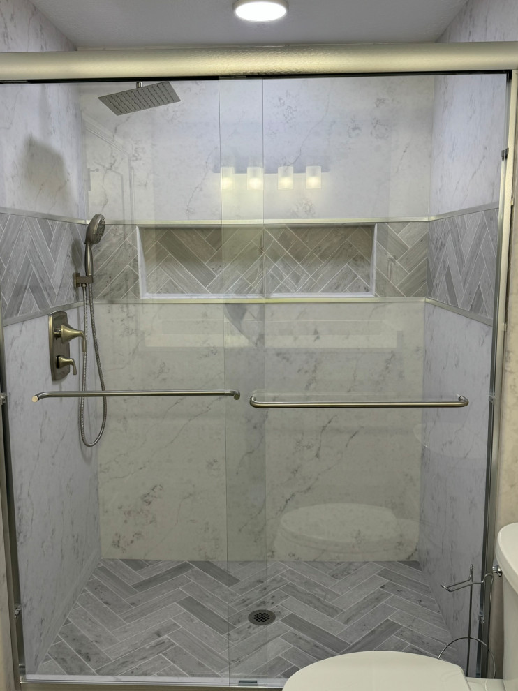 Basement bathroom solid surface shower after  sliding shower glass installation.