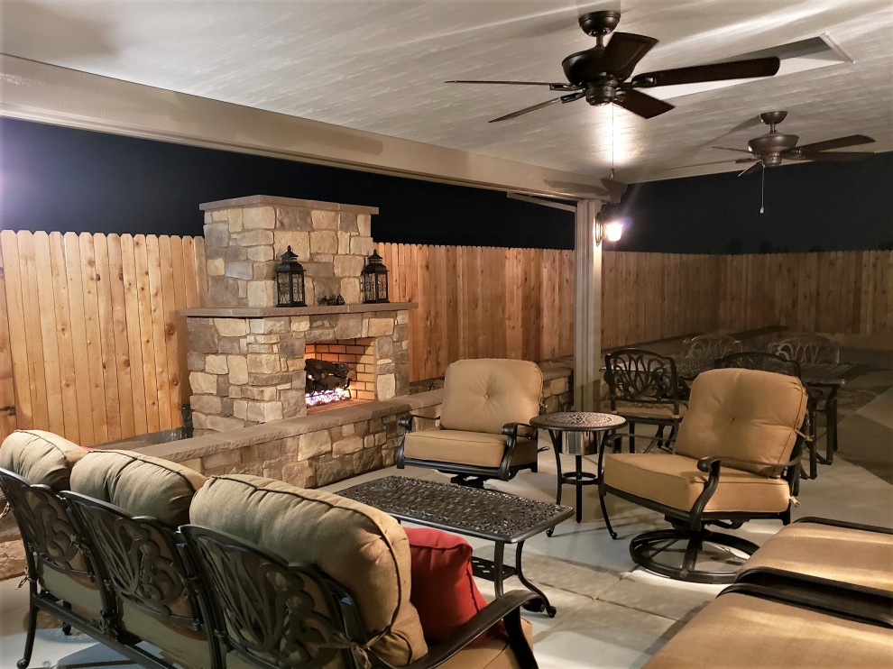 Mid-sized arts and crafts backyard patio in Other with with fireplace, concrete slab and a pergola.