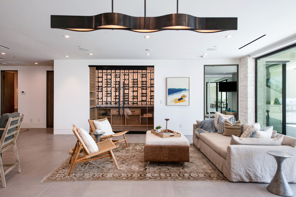 Inspiration for a large contemporary open concept living room in Orange County with white walls, light hardwood floors, a ribbon fireplace, a stone fireplace surround, no tv and beige floor.