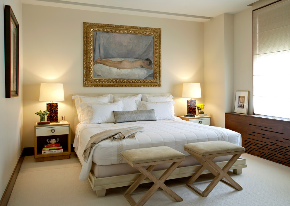Photo of a mid-sized transitional bedroom in New York with beige walls and carpet.