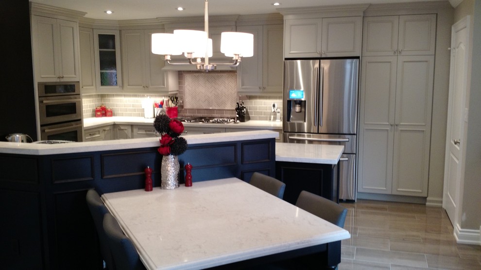 Eat-in kitchen - mid-sized transitional l-shaped porcelain tile eat-in kitchen idea in Toronto with an undermount sink, recessed-panel cabinets, porcelain backsplash, stainless steel appliances and a peninsula