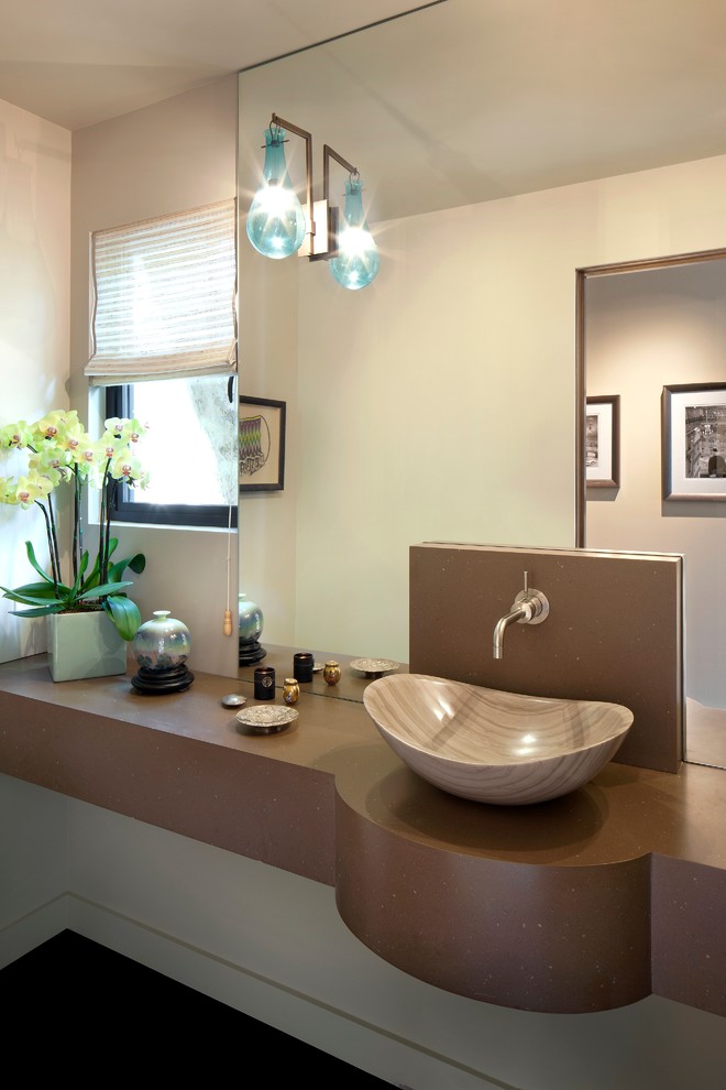 This is an example of a large midcentury powder room in Los Angeles with open cabinets, a two-piece toilet, beige walls and a vessel sink.