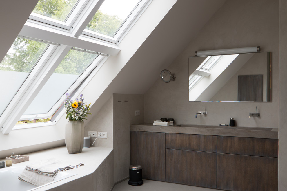 Photo of a large contemporary master bathroom in Berlin with flat-panel cabinets, a drop-in tub, grey walls, dark wood cabinets, stone slab, an integrated sink, marble benchtops, grey floor and an open shower.