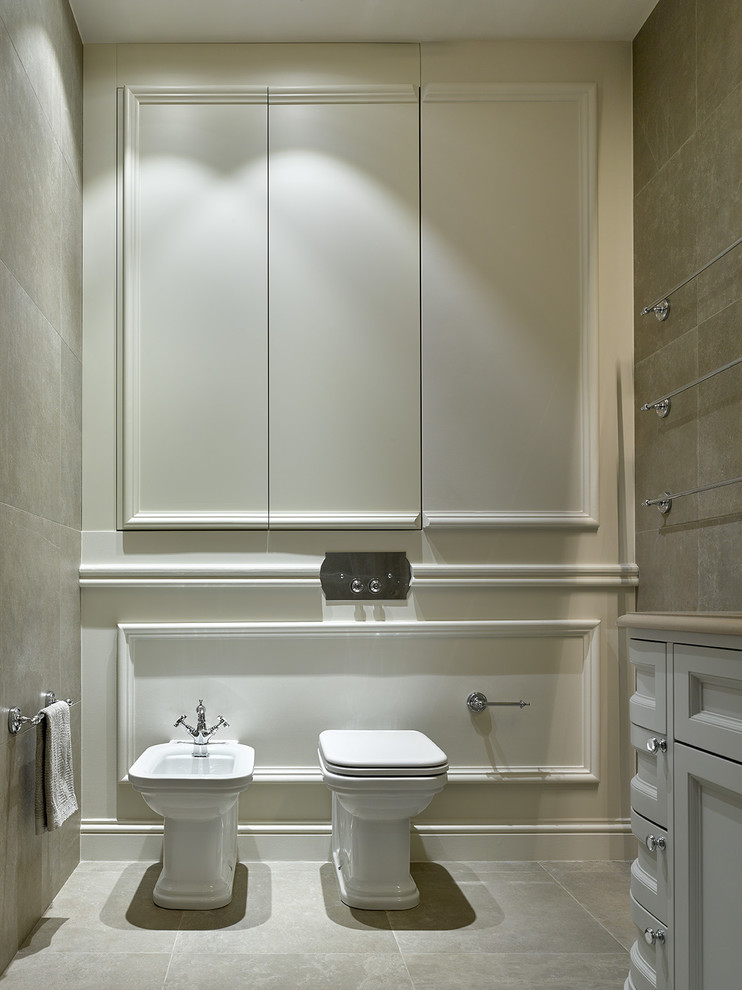 Traditional powder room in Moscow with a bidet, white walls, recessed-panel cabinets, white cabinets and grey floor.