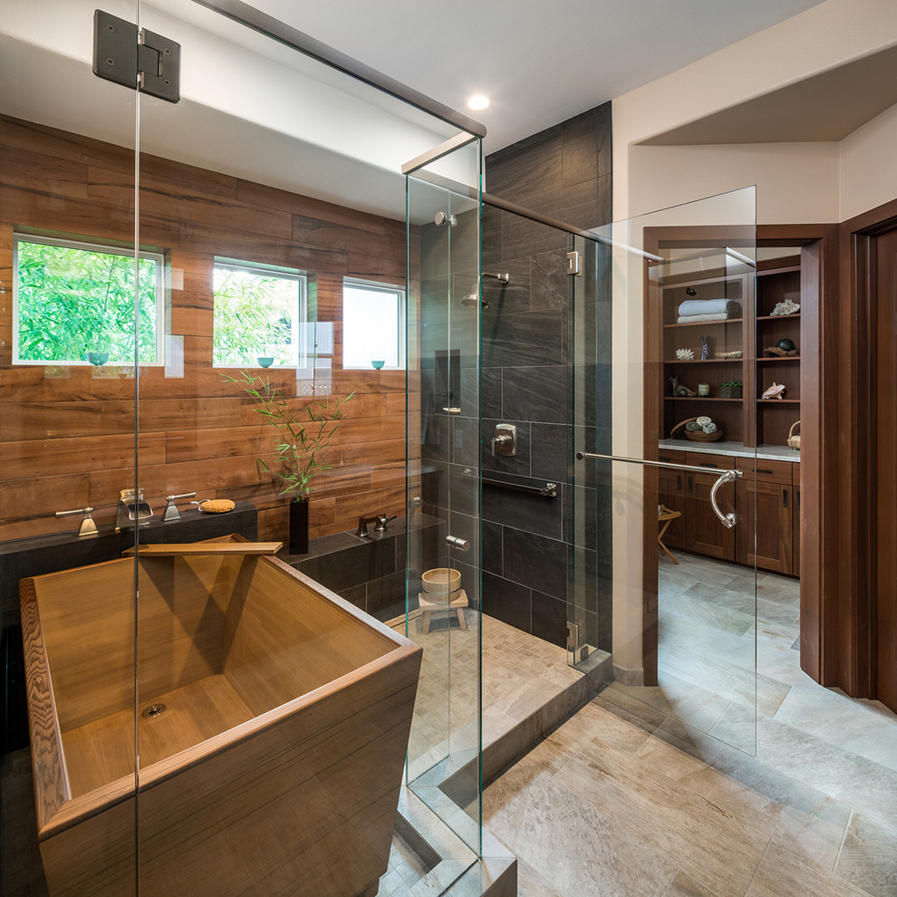 Photo of a large asian master bathroom in Portland with recessed-panel cabinets, medium wood cabinets, a japanese tub, an alcove shower, a one-piece toilet, beige tile, porcelain tile, beige walls, porcelain floors, an undermount sink, quartzite benchtops, beige floor, a hinged shower door and beige benchtops.