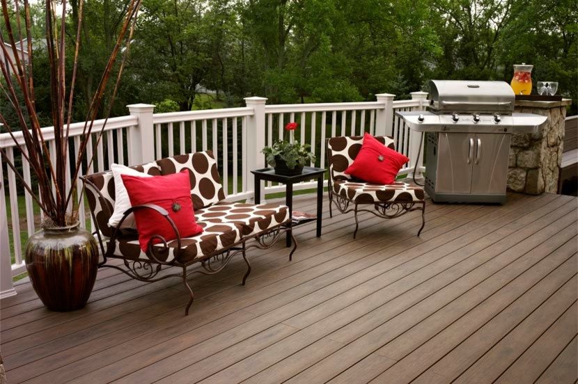 This is an example of a mid-sized contemporary backyard deck in Grand Rapids with an outdoor kitchen and no cover.