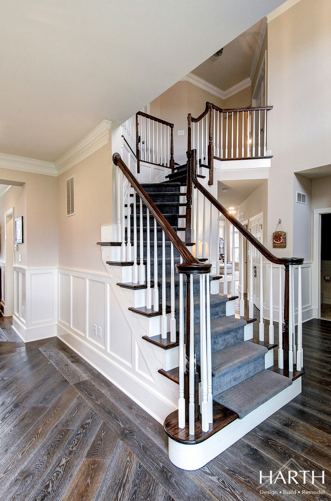 Design ideas for a mid-sized transitional foyer in Philadelphia with grey walls, dark hardwood floors, a single front door, a white front door, brown floor and decorative wall panelling.