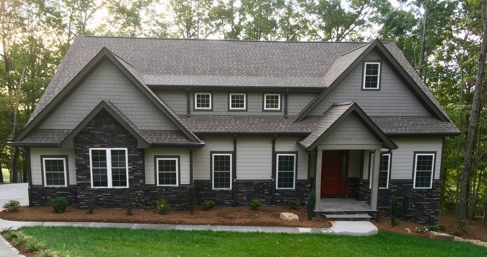 This is an example of a large country one-storey grey house exterior in Other with concrete fiberboard siding, a gable roof and a shingle roof.