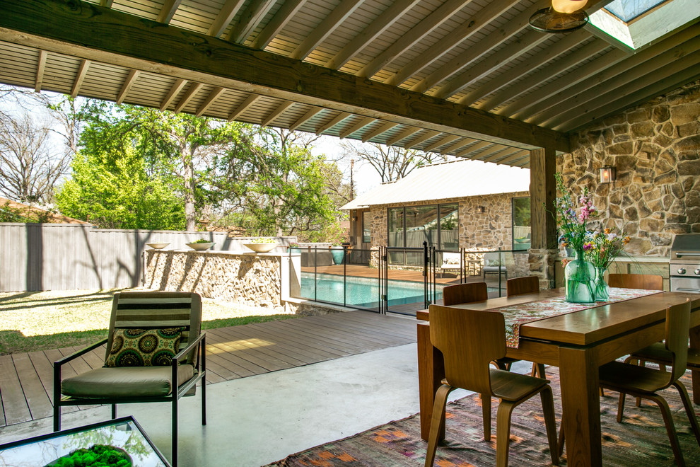 Photo of a country backyard patio in Dallas with a roof extension.