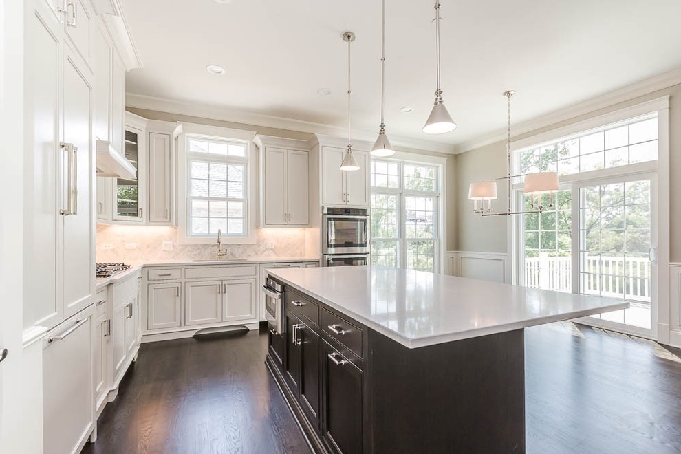 Inspiration for a mid-sized transitional l-shaped dark wood floor eat-in kitchen remodel in Chicago with shaker cabinets, white cabinets, gray backsplash, stone tile backsplash, stainless steel appliances and an island