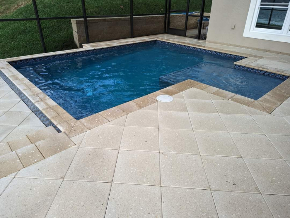 Inspiration for a small backyard brick and custom-shaped hot tub remodel in Orlando