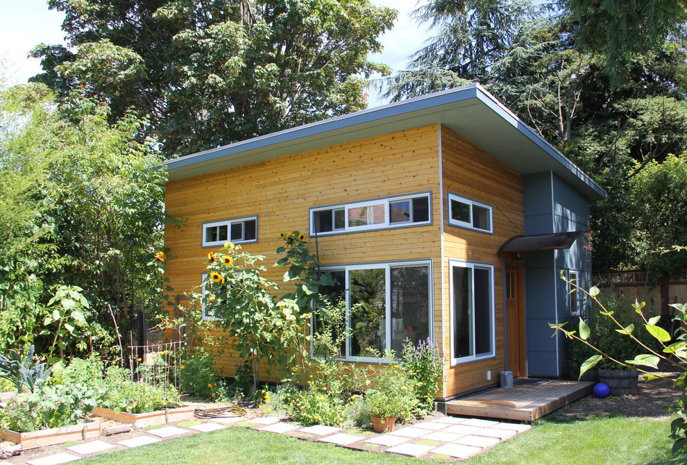 Small contemporary one-storey exterior in Seattle with wood siding and a shed roof.