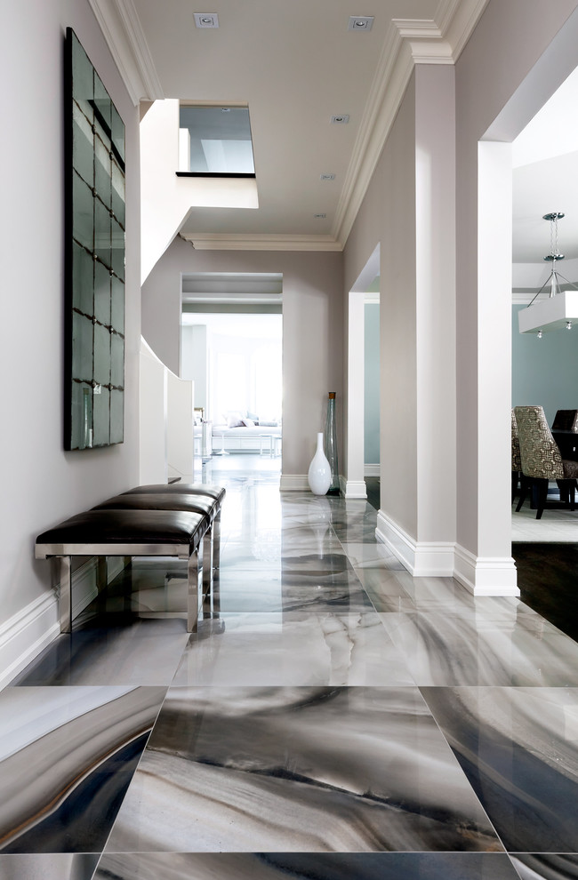 Inspiration for a contemporary foyer in Toronto with grey walls and grey floor.
