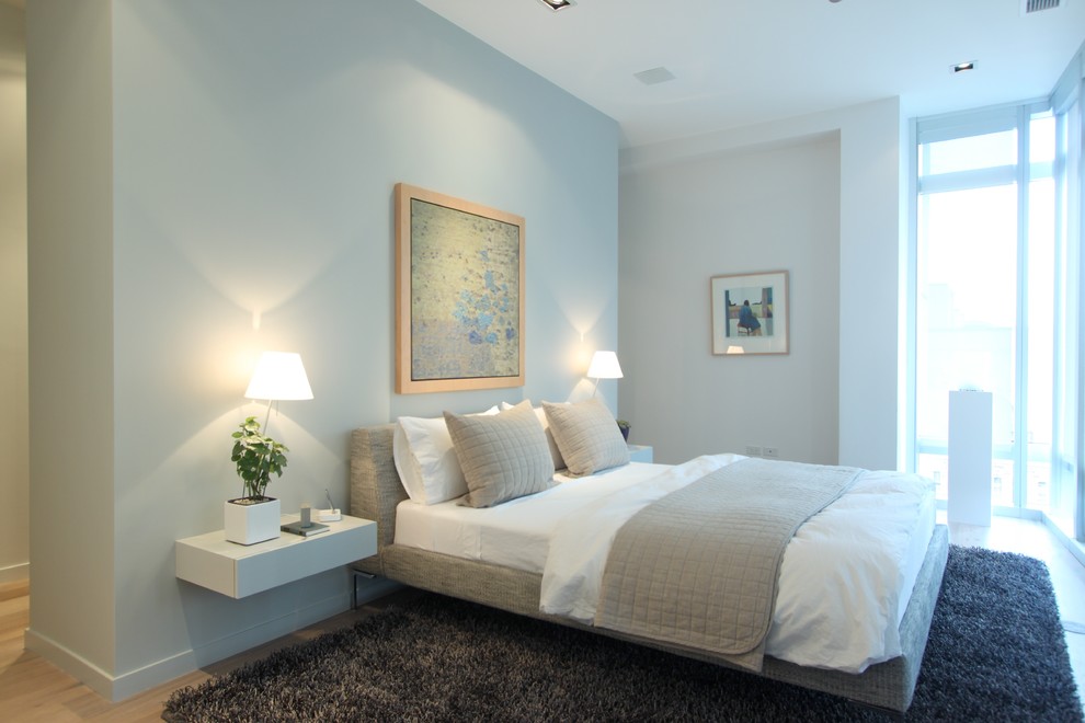 Bedroom - small modern master light wood floor bedroom idea in Chicago with white walls