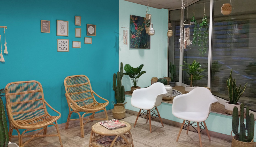 Design ideas for a mid-sized tropical home office in Marseille with blue walls, laminate floors, no fireplace and brown floor.