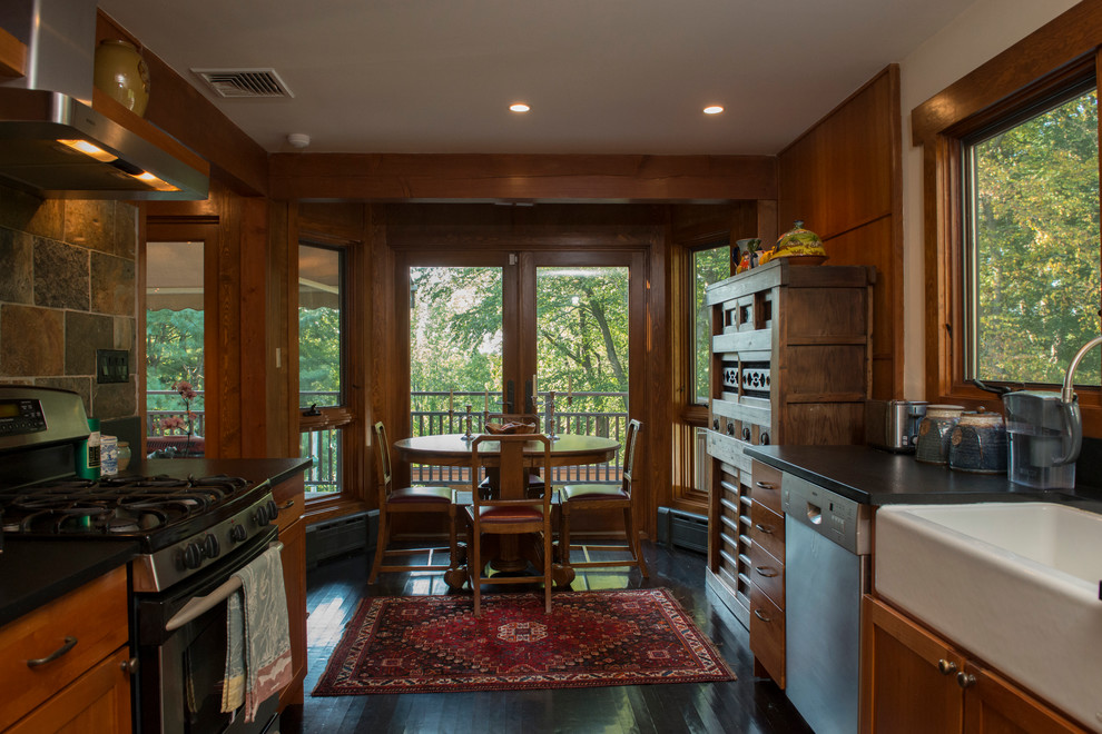 Mid-sized asian galley eat-in kitchen in New York with a farmhouse sink, recessed-panel cabinets, medium wood cabinets, stainless steel appliances, dark hardwood floors and no island.