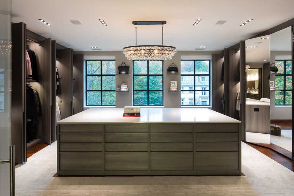 Walk-in closet - contemporary women's carpeted and beige floor walk-in closet idea in DC Metro with flat-panel cabinets and medium tone wood cabinets
