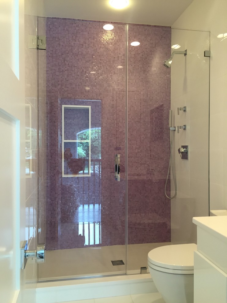 Design ideas for a contemporary bathroom in New York with an alcove shower, a two-piece toilet and mosaic tile.
