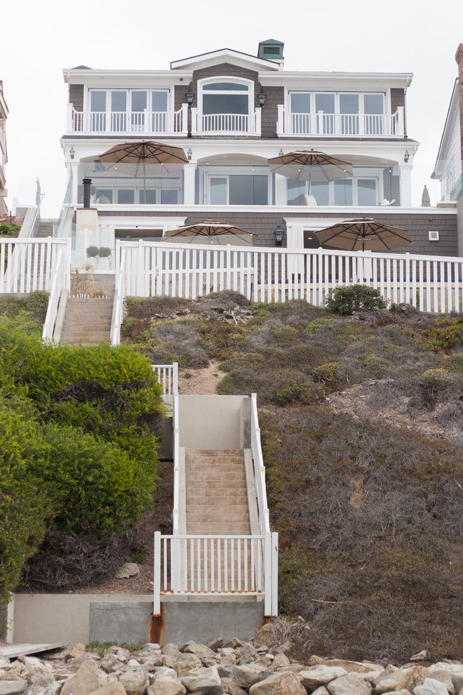 This is an example of a beach style three-storey brown exterior in Orange County.