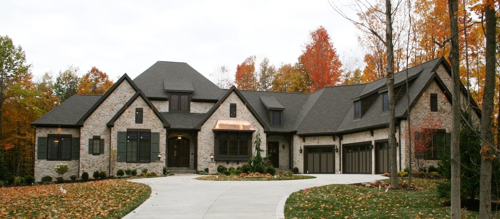 Photo of an eclectic one-storey exterior in Cleveland with stone veneer.