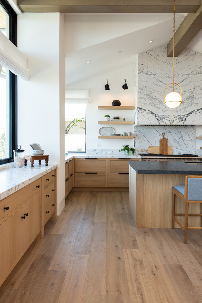 Mid-sized transitional u-shaped eat-in kitchen in Orange County with an undermount sink, recessed-panel cabinets, light wood cabinets, marble benchtops, white splashback, stone slab splashback, panelled appliances, light hardwood floors, with island, beige floor and white benchtop.