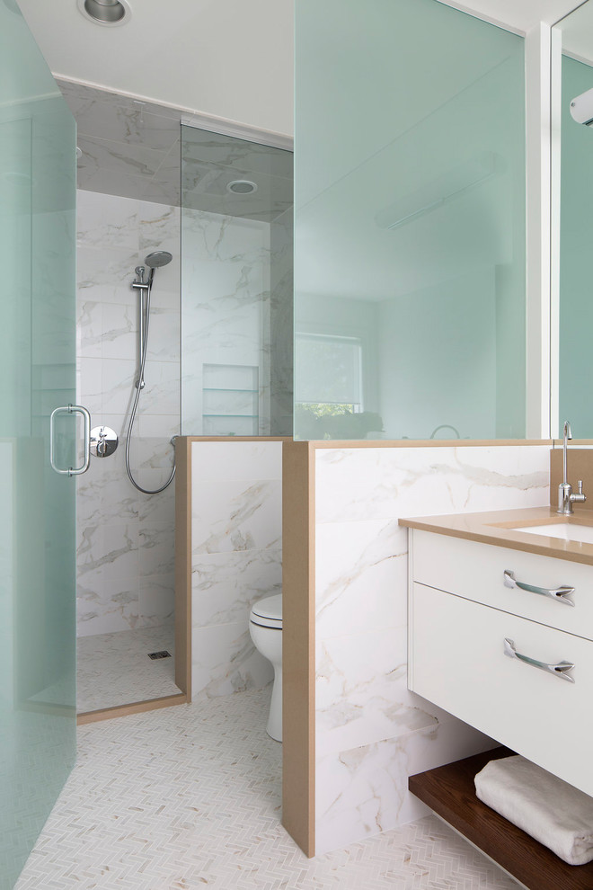 This is an example of a large contemporary master bathroom in Calgary with flat-panel cabinets, white cabinets, an alcove shower, white tile, an undermount sink, a drop-in tub, marble, white walls, marble floors, engineered quartz benchtops, multi-coloured floor, a hinged shower door and brown benchtops.
